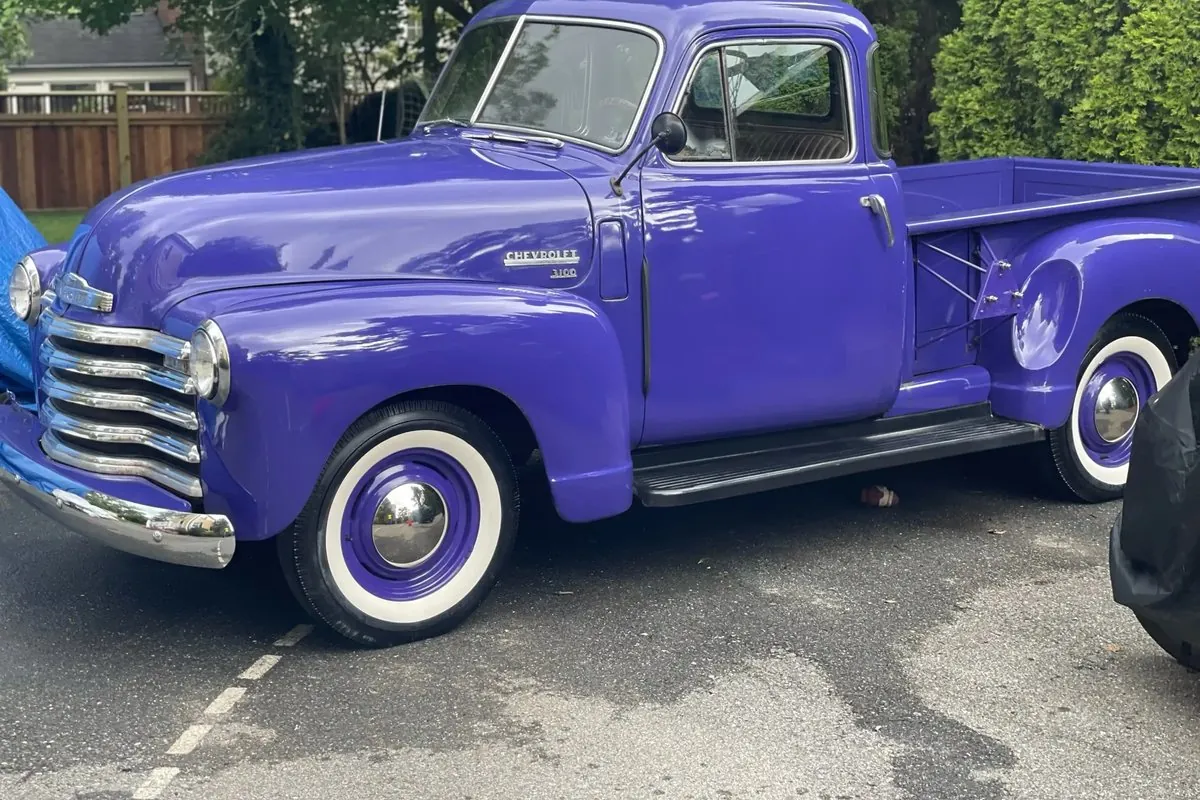 Detailed purple vintage Chevrolet pickup truck with whitewall tires