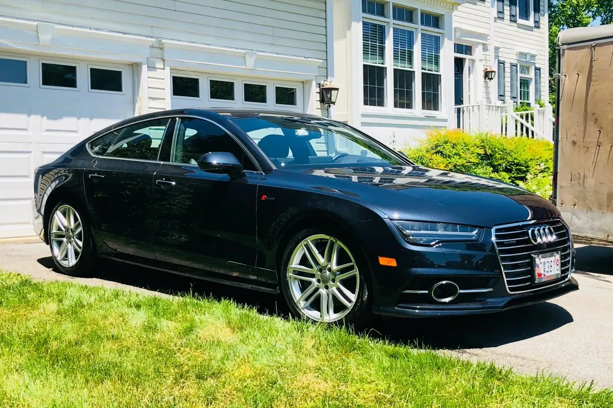 Black Audi A7 with a fresh wax shine in a driveway